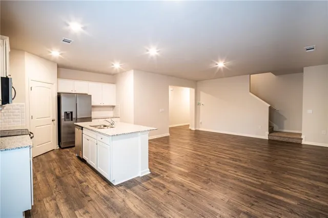 a kitchen with a stove a sink and a refrigerator