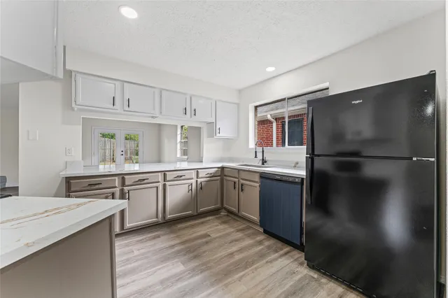 a kitchen with a refrigerator and a sink