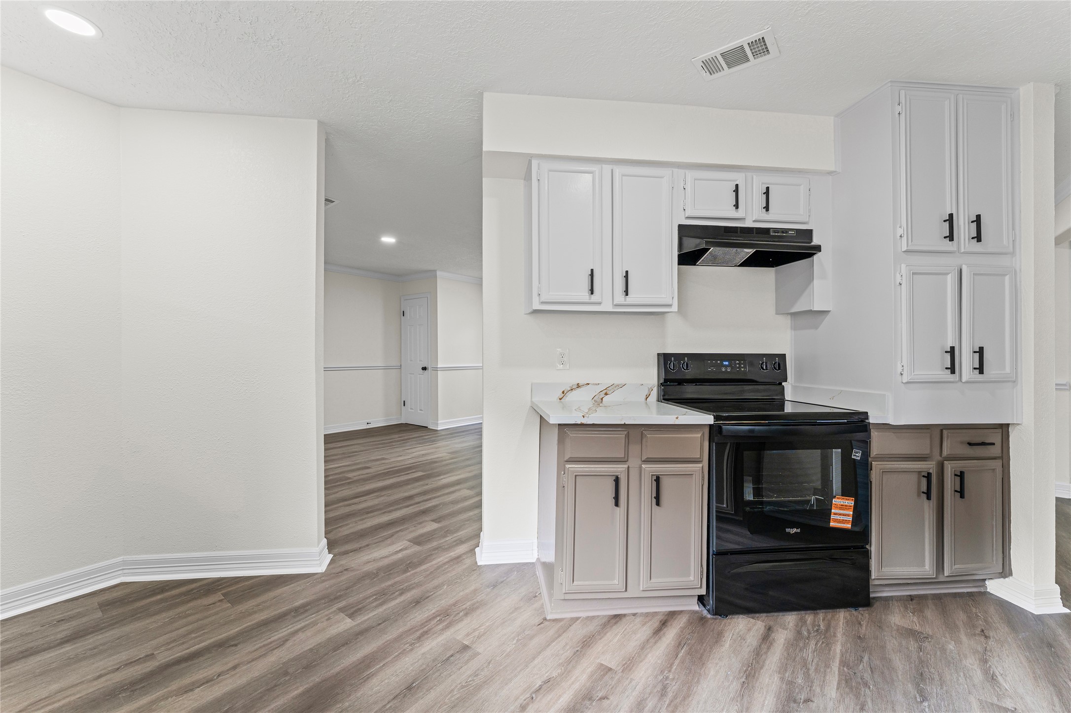 1506 Leadenhall Circle Channelview, TX 77530 - Photo 12 of 34 a kitchen with a stove and wooden floor