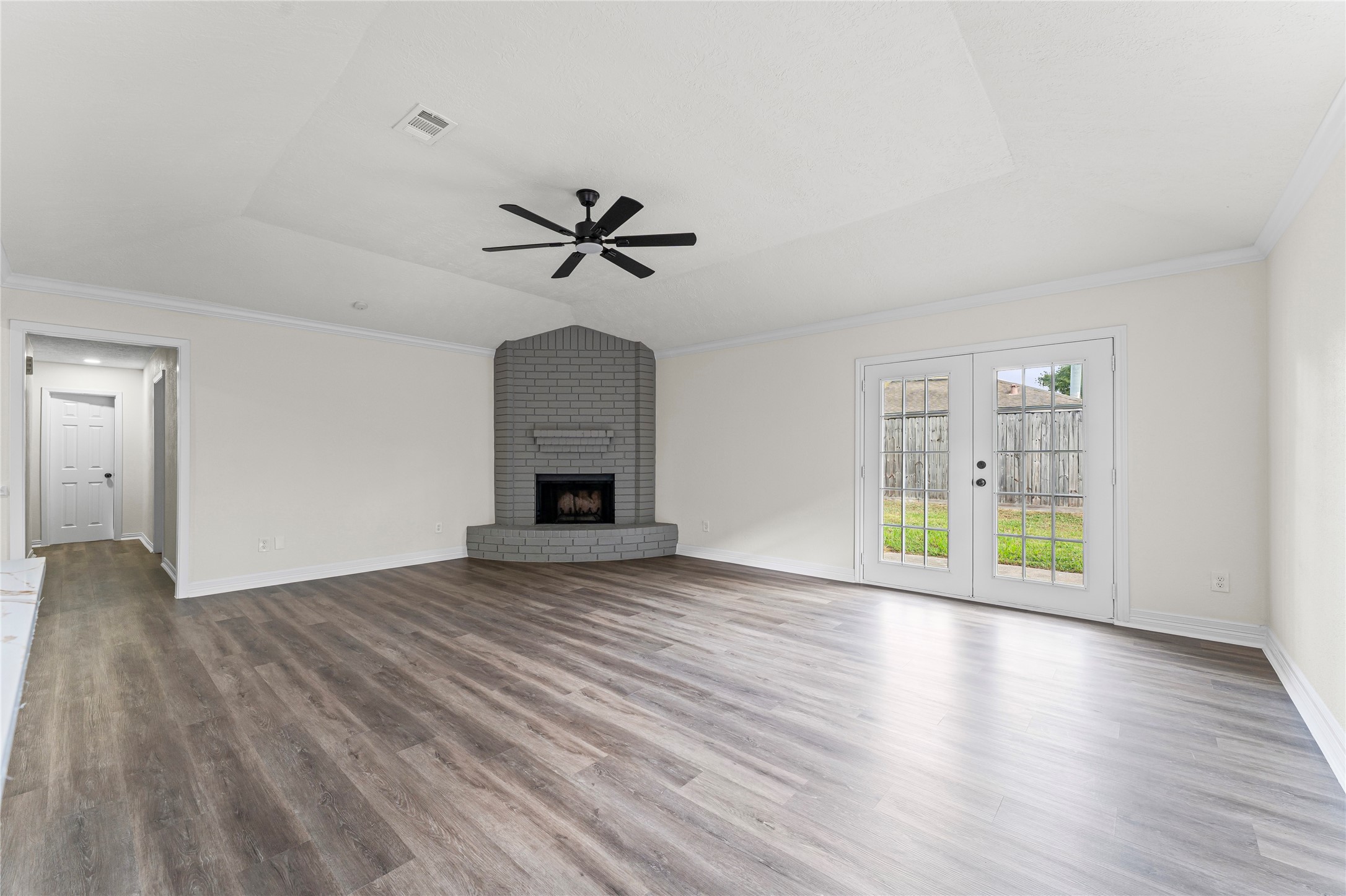 1506 Leadenhall Circle Channelview, TX 77530 - Photo 15 of 34 a view of an empty room with wooden floor and a window