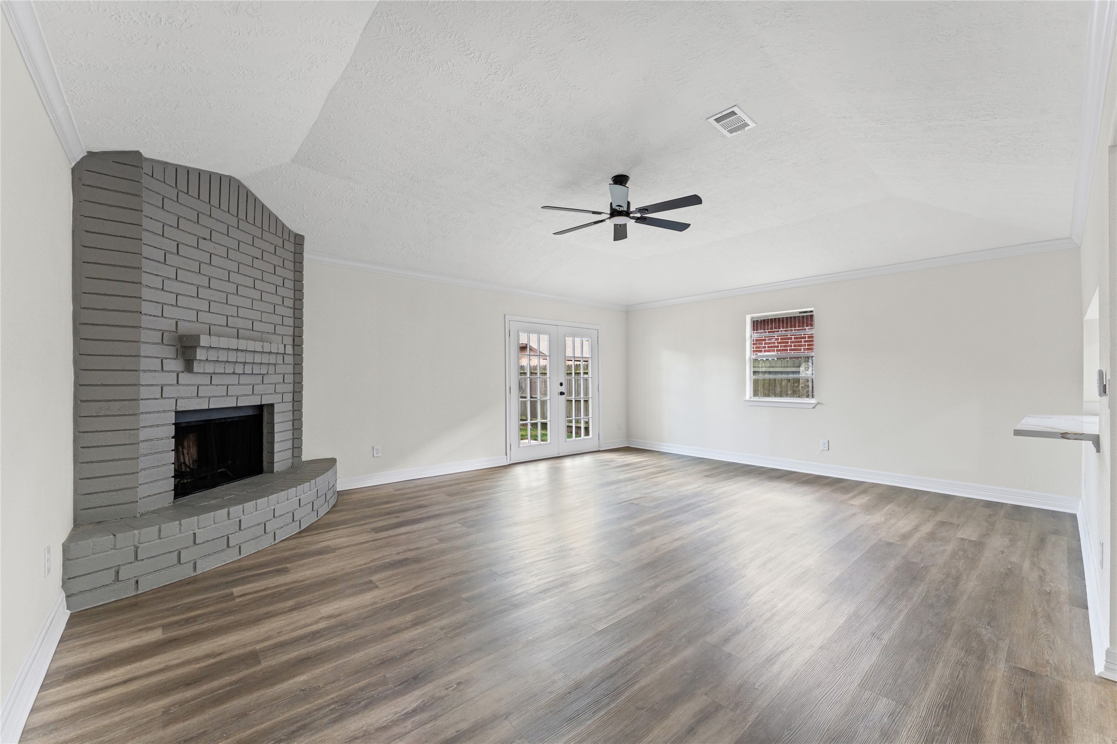 1506 Leadenhall Circle Channelview, TX 77530 - Photo 16 of 34 a view of an empty room with wooden floor fireplace and a window