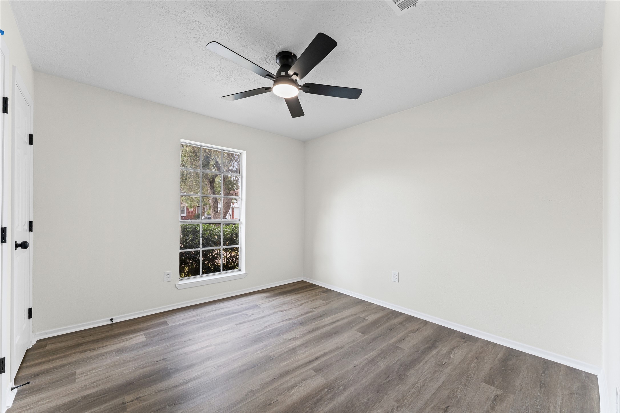 1506 Leadenhall Circle Channelview, TX 77530 - Photo 23 of 34 an empty room with wooden floor fan and windows