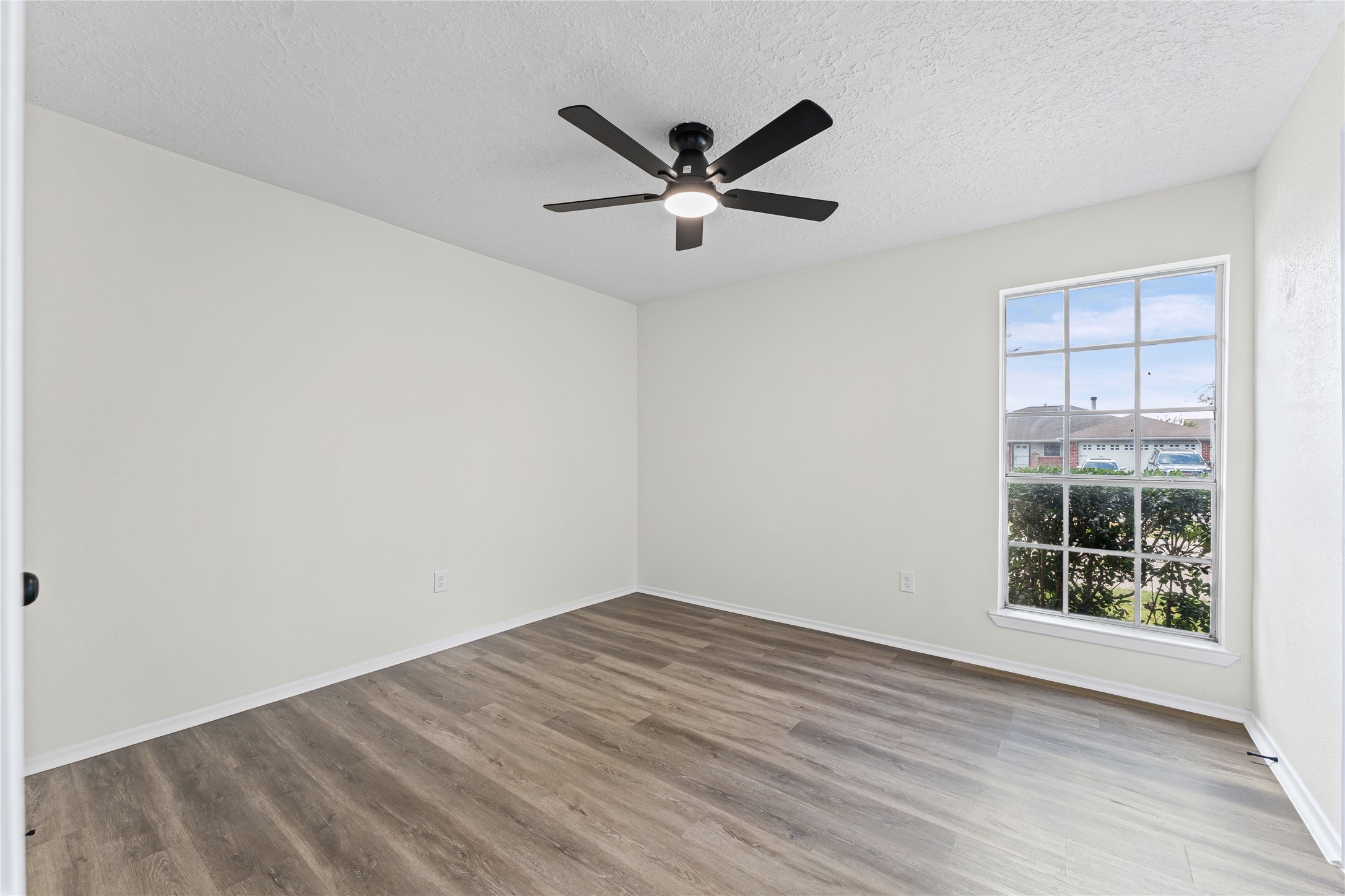 1506 Leadenhall Circle Channelview, TX 77530 - Photo 24 of 34 an empty room with wooden floor and windows