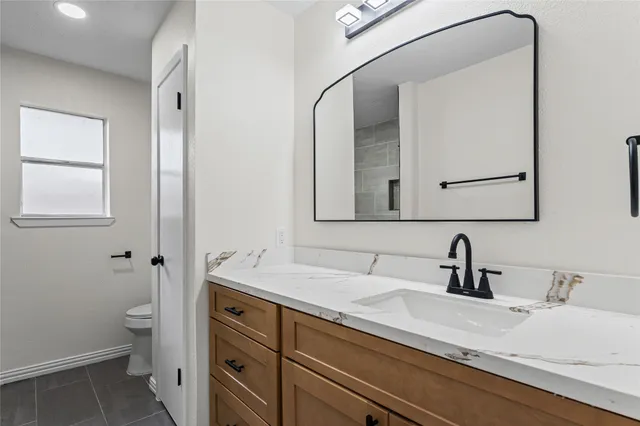 a bathroom with a double vanity sink and mirror