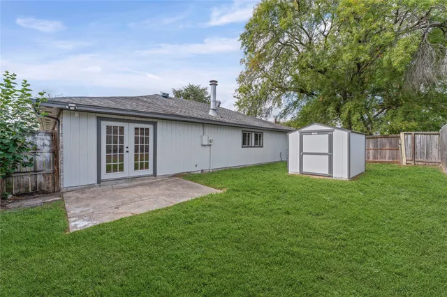 a view of backyard of house with green space
