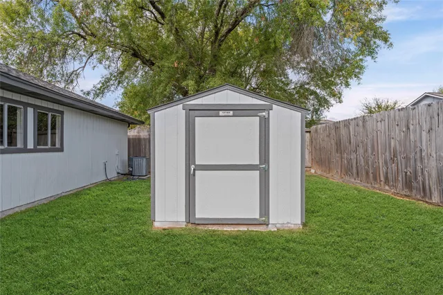 a house with green field in front of it