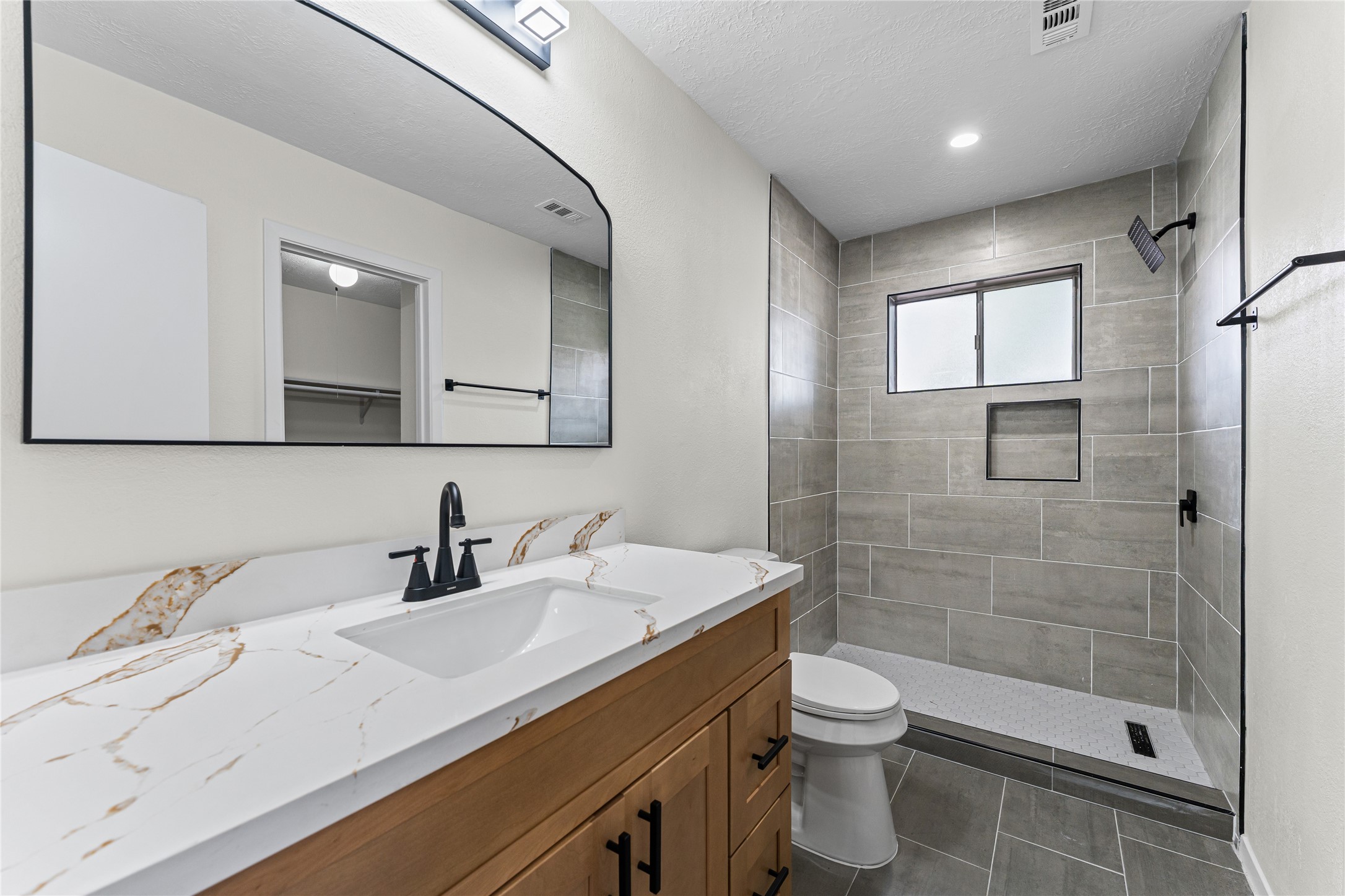1506 Leadenhall Circle Channelview, TX 77530 - Photo 5 of 34 a bathroom with a sink a toilet and shower
