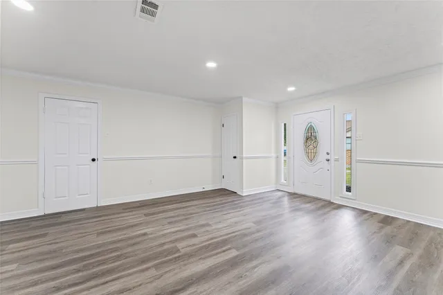 an empty room with wooden floor