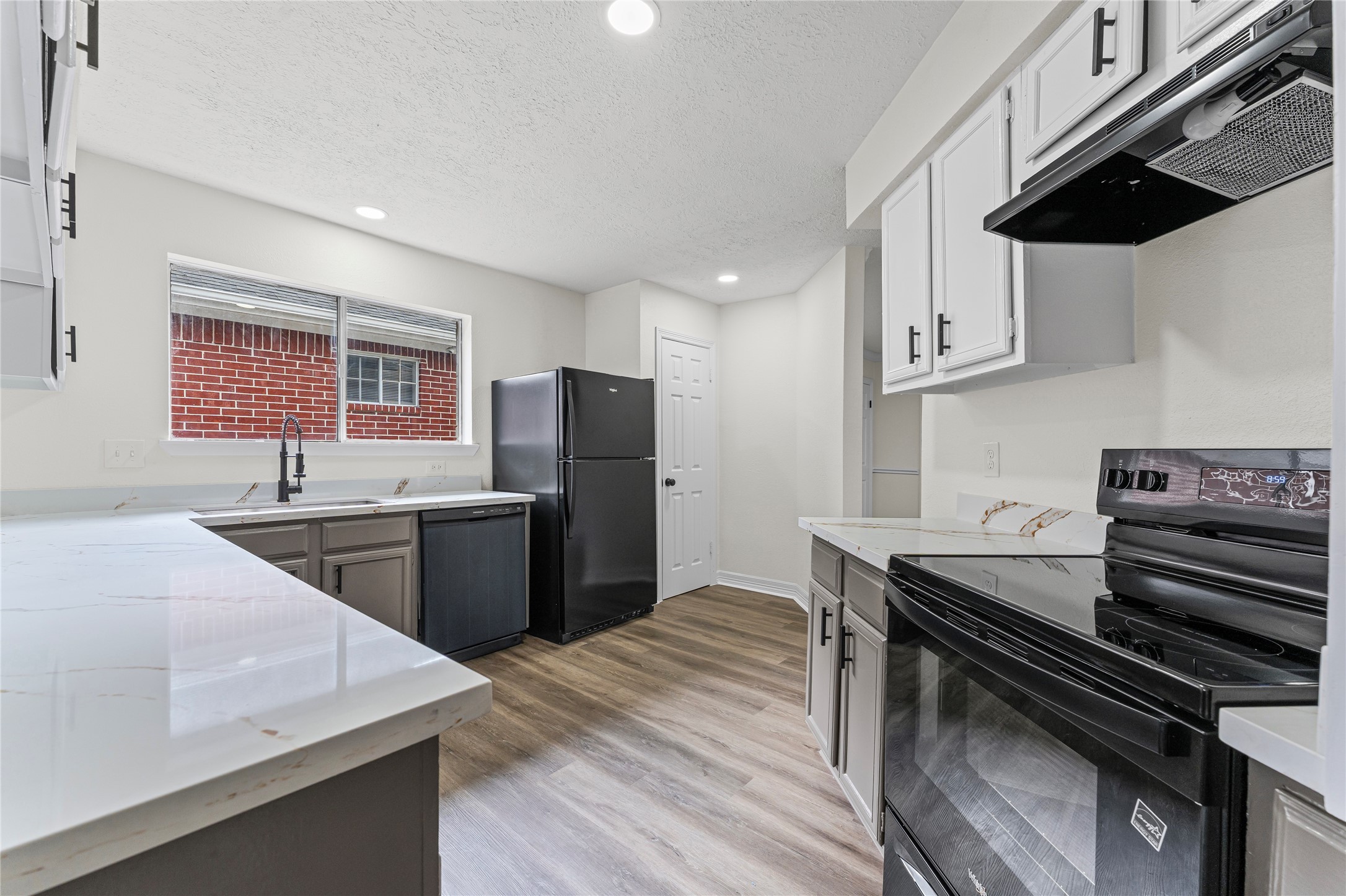 1506 Leadenhall Circle Channelview, TX 77530 - Photo 9 of 34 a kitchen with stainless steel appliances kitchen island a sink dishwasher a stove a refrigerator and cabinets