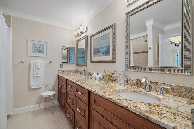 a bathroom with a granite countertop sink mirror and toilet