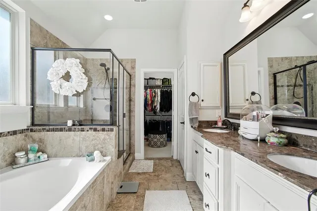 a spacious bathroom with a double vanity sink and a mirror