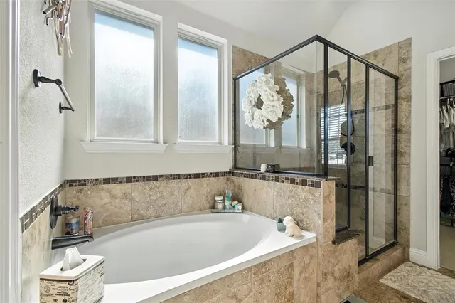 a bathroom with a bathtub and shower