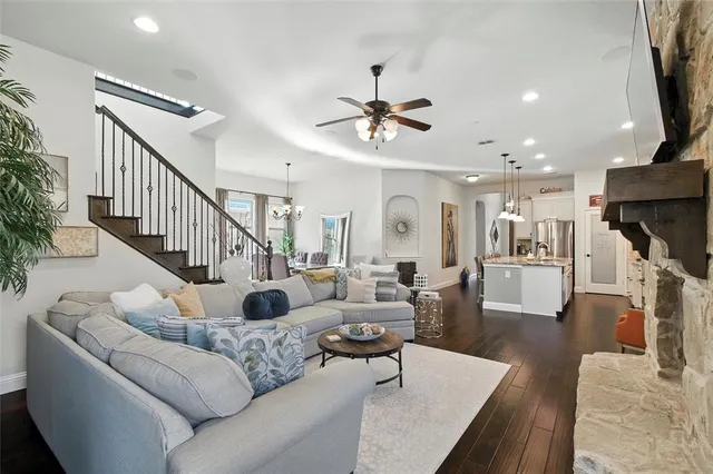 a living room with furniture a fireplace and a flat screen tv
