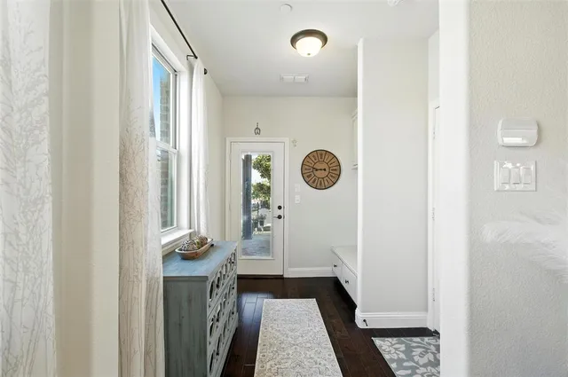 a view of a hallway to a livingroom with furniture