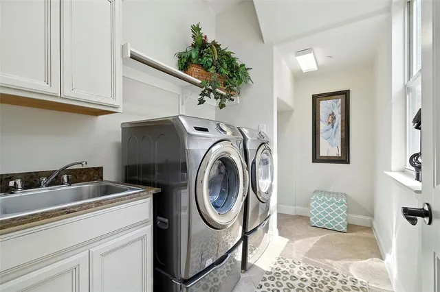 a utility room with sink dryer and washer