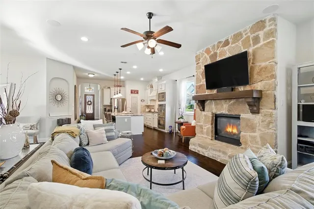 a living room with furniture a flat screen tv and a fireplace