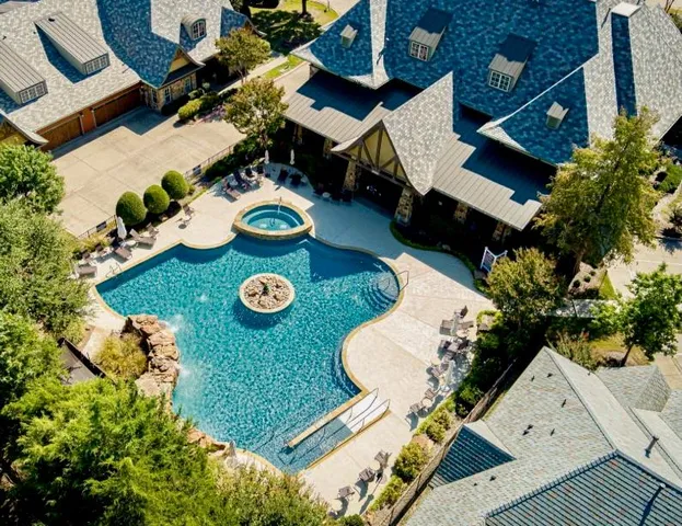 an aerial view of a house roof deck and patio