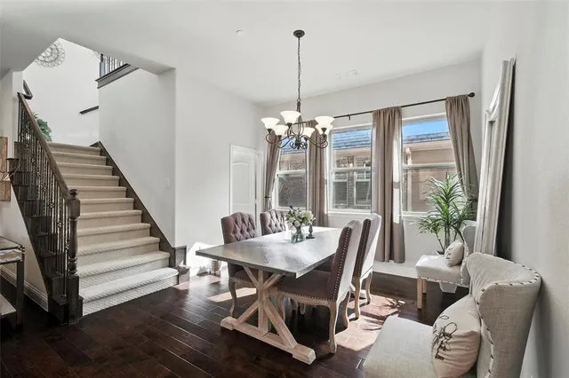 a view of a livingroom with furniture wooden floor and a chandelier