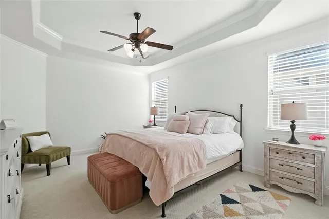 a bedroom with a bed a chandelier and a chair