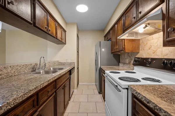 a kitchen with a sink stove and refrigerator