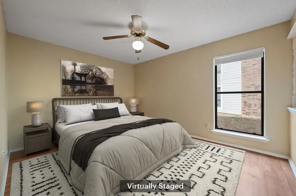 a bedroom with a large bed and a window