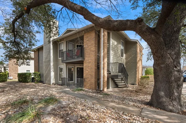 a view of a house with a tree in the background