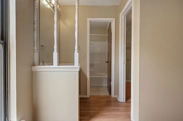 a view of small space with wooden floor and closet