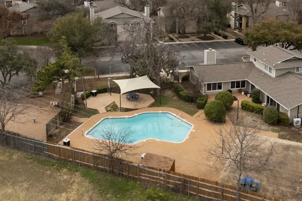 an aerial view of a house with yard