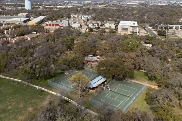 an aerial view of a house with a yard and lake view