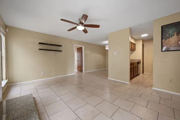 a view of a livingroom with a ceiling fan and window