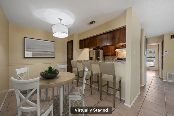 a dining room with furniture and chandelier