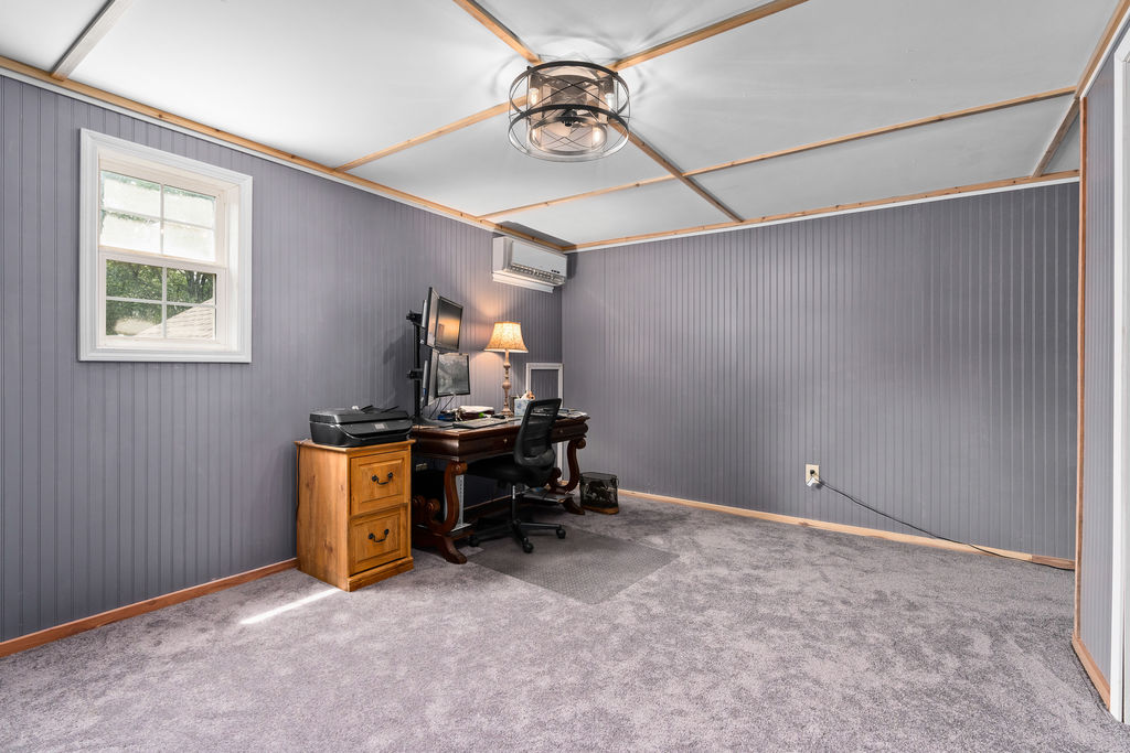 365 Calihan Road Booneville, AR 72927 - Photo 50 of 59 Carpeted interior space featuring beadboard paneling, white trim, and a window for natural light