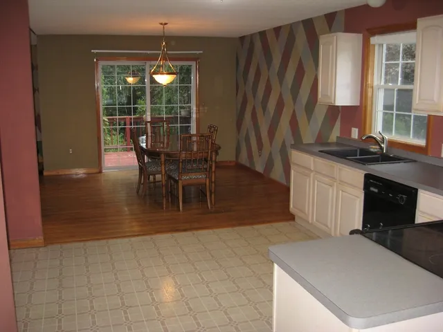 a view of a dining room with furniture and window