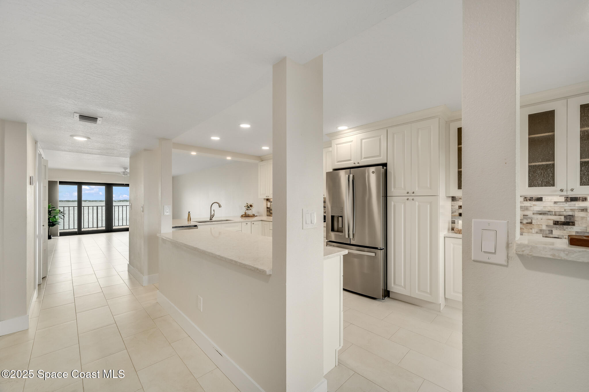 3220 River Villa Way, Unit 141 Melbourne Beach, FL 32951 - Photo 11 of 79 a view of a kitchen with a refrigerator and a sink