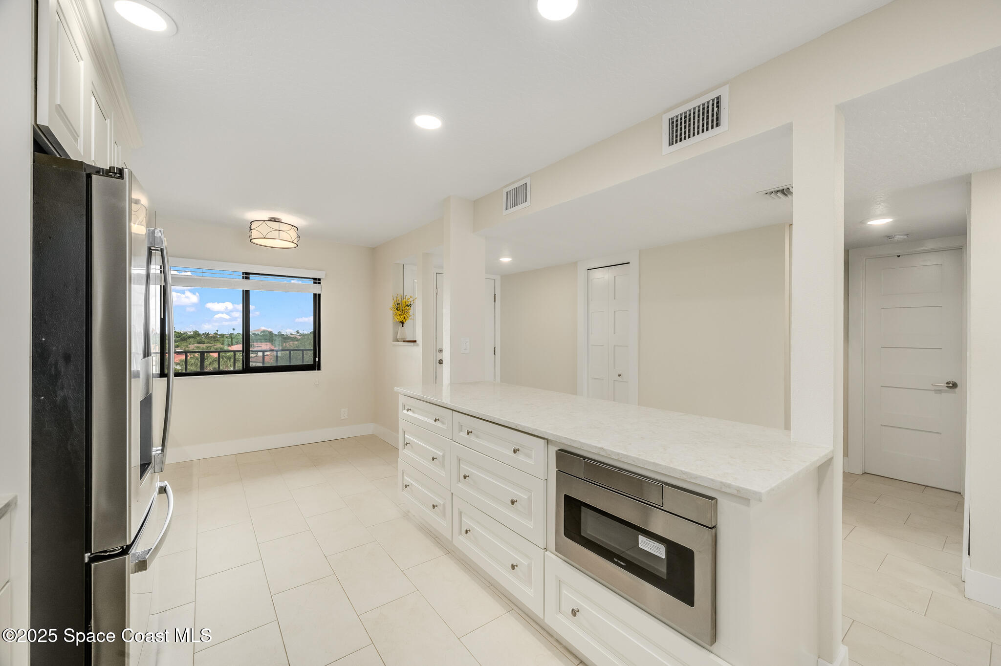 3220 River Villa Way, Unit 141 Melbourne Beach, FL 32951 - Photo 13 of 79 a view of kitchen with granite countertop cabinets and refrigerator