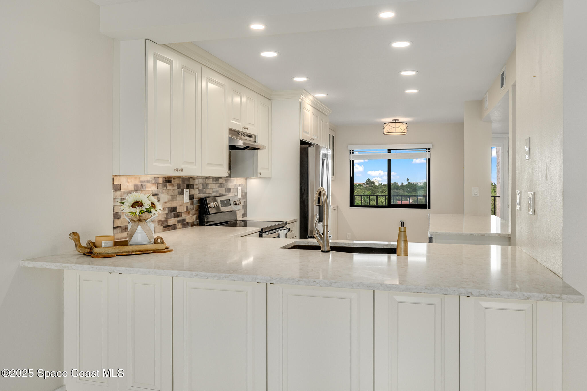 3220 River Villa Way, Unit 141 Melbourne Beach, FL 32951 - Photo 14 of 79 a view of kitchen with kitchen island stainless steel appliances a sink and cabinets