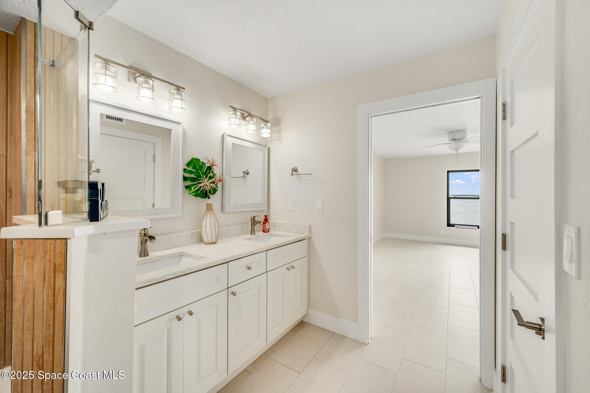 3220 River Villa Way, Unit 141 Melbourne Beach, FL 32951 - Photo 19 of 79 a bathroom with a double vanity sink mirror and