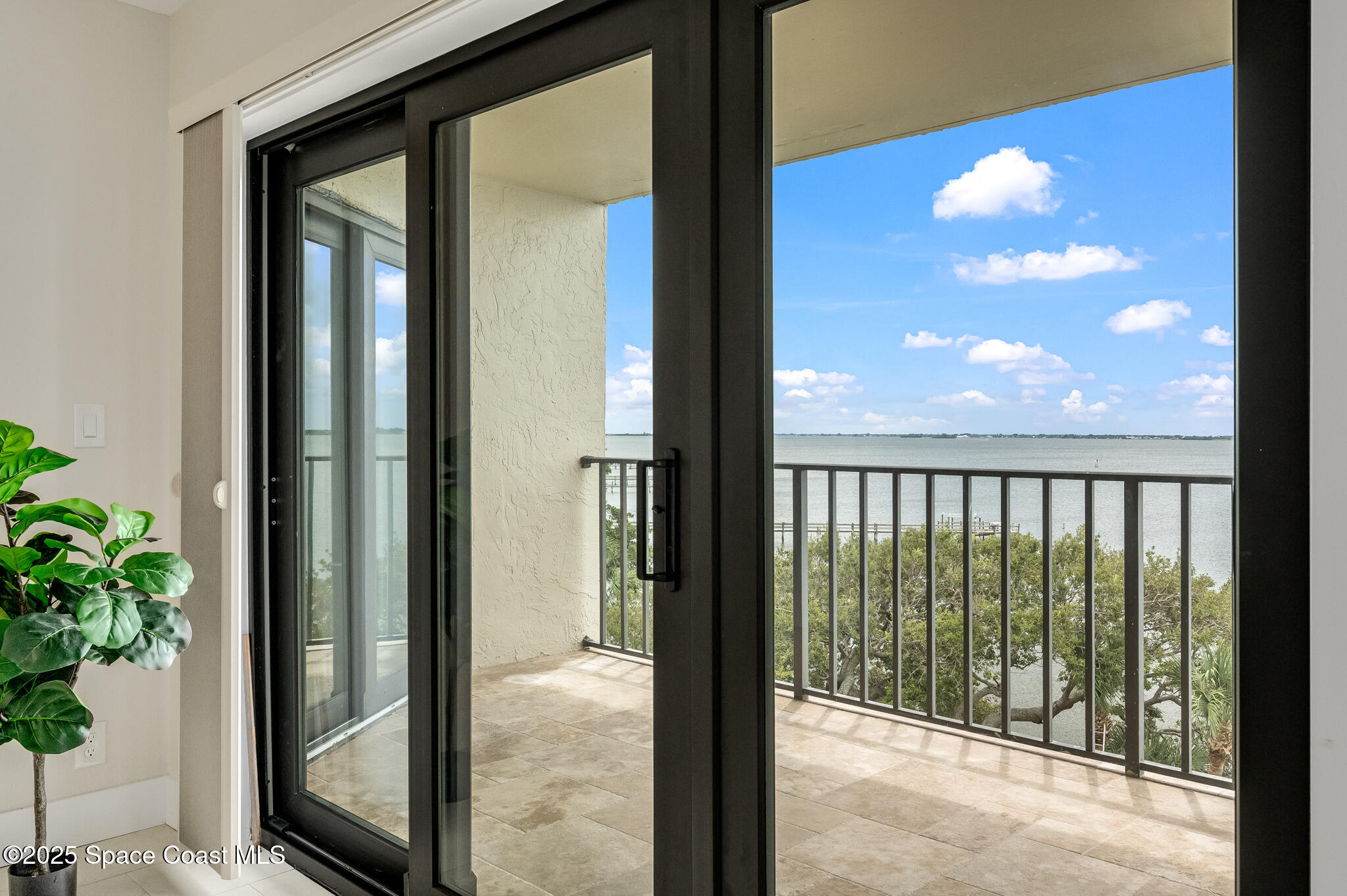 3220 River Villa Way, Unit 141 Melbourne Beach, FL 32951 - Photo 22 of 79 a view of a glass door with a balcony