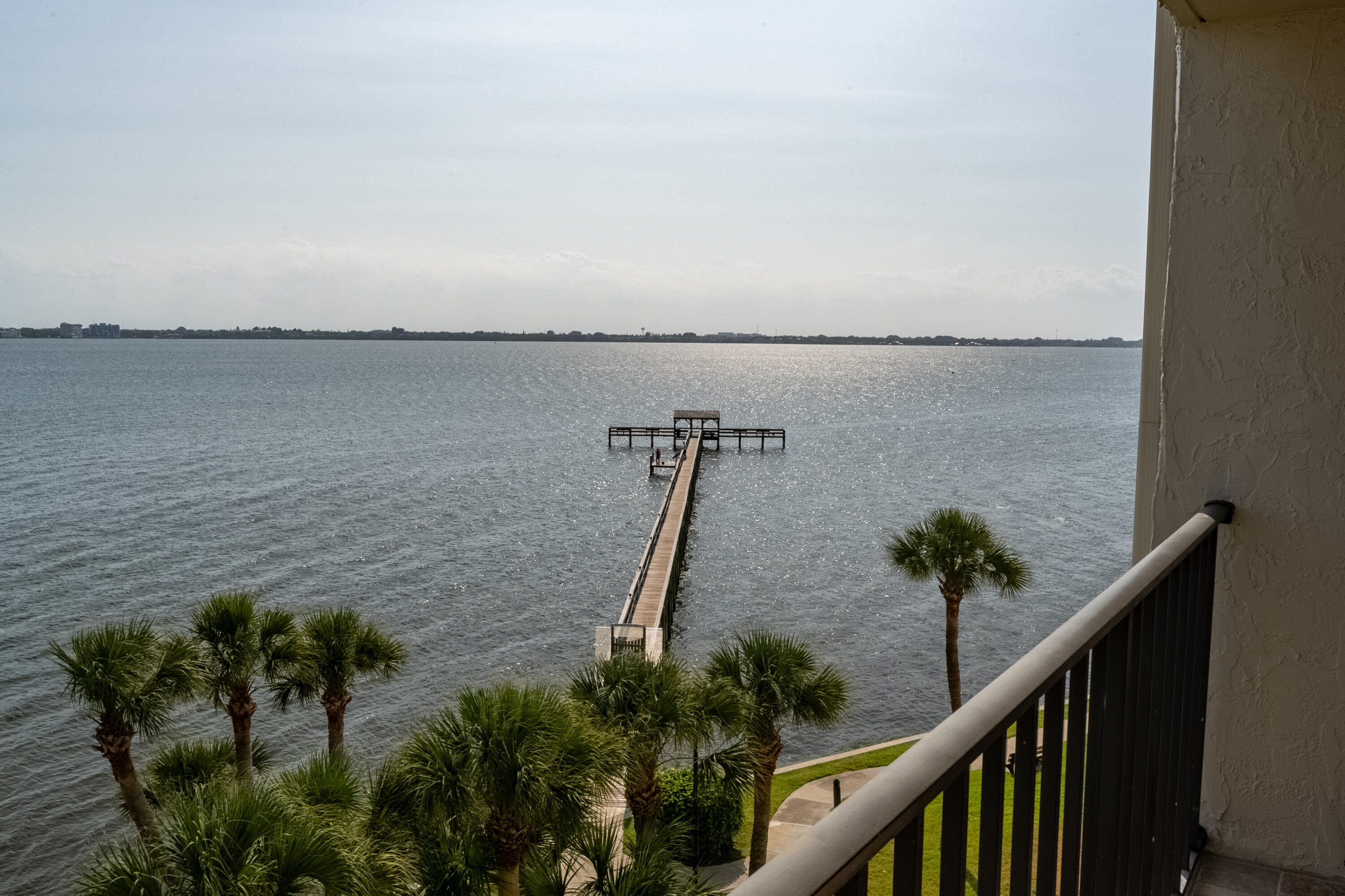 3220 River Villa Way, Unit 141 Melbourne Beach, FL 32951 - Photo 49 of 79 a view of a balcony with chairs and wooden floor