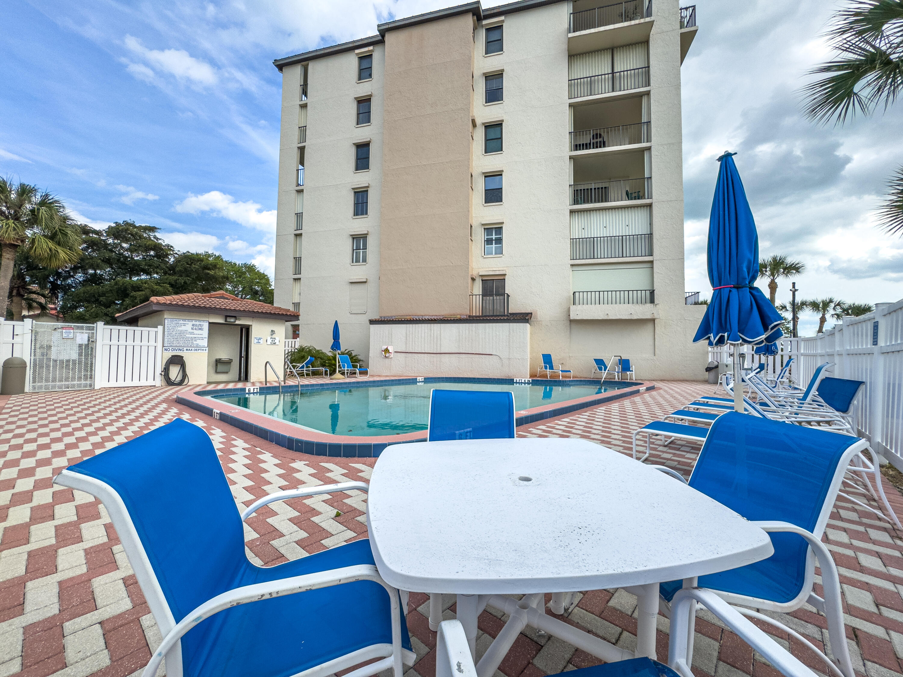 3220 River Villa Way, Unit 141 Melbourne Beach, FL 32951 - Photo 55 of 79 a table and chairs in front of a white house