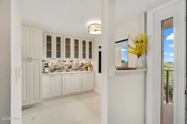 a view of a kitchen with a sink and a chandelier