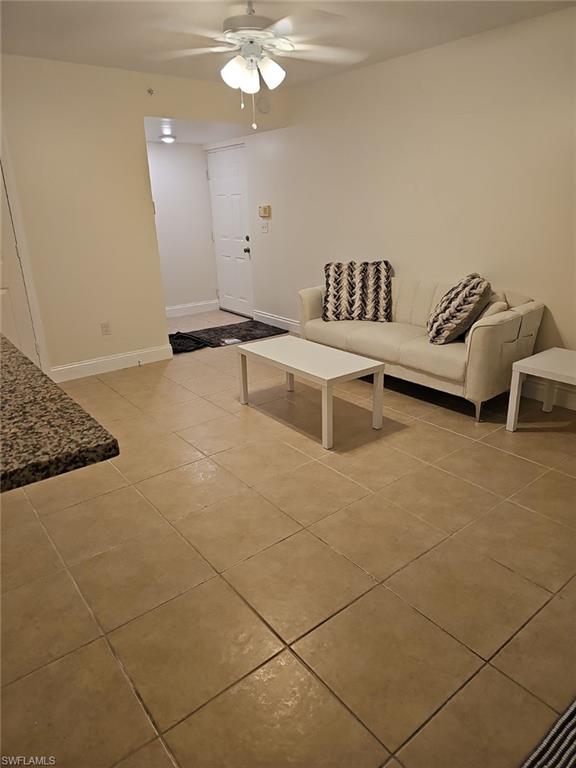 1840 Florida Club Circle, Unit 5206 Naples, FL 34112 - Photo 3 of 13 a bedroom with a bed and a chandelier