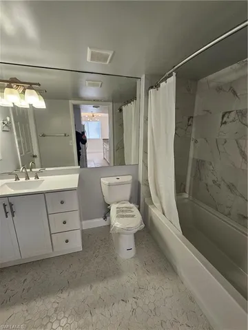 a bathroom with a toilet sink and shower
