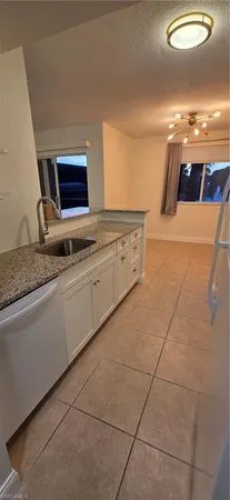 a view of a kitchen with granite countertop cabinets and a sink