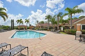 1840 Florida Club Circle, Unit 5206 Naples, FL 34112 - Photo 10 of 13 a swimming pool with outdoor seating and yard