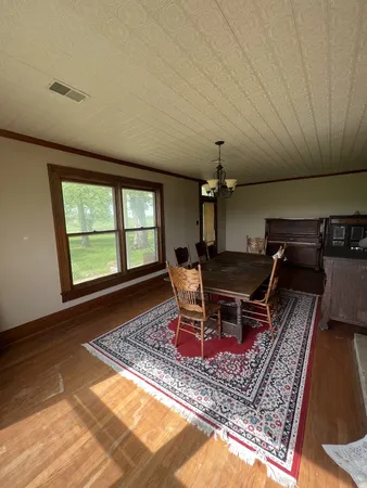 a living room with furniture a rug and a window
