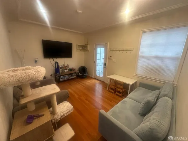 a living room with furniture and a flat screen tv