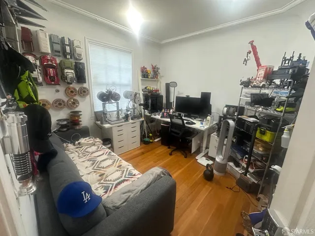 a bedroom with a bed and large windows