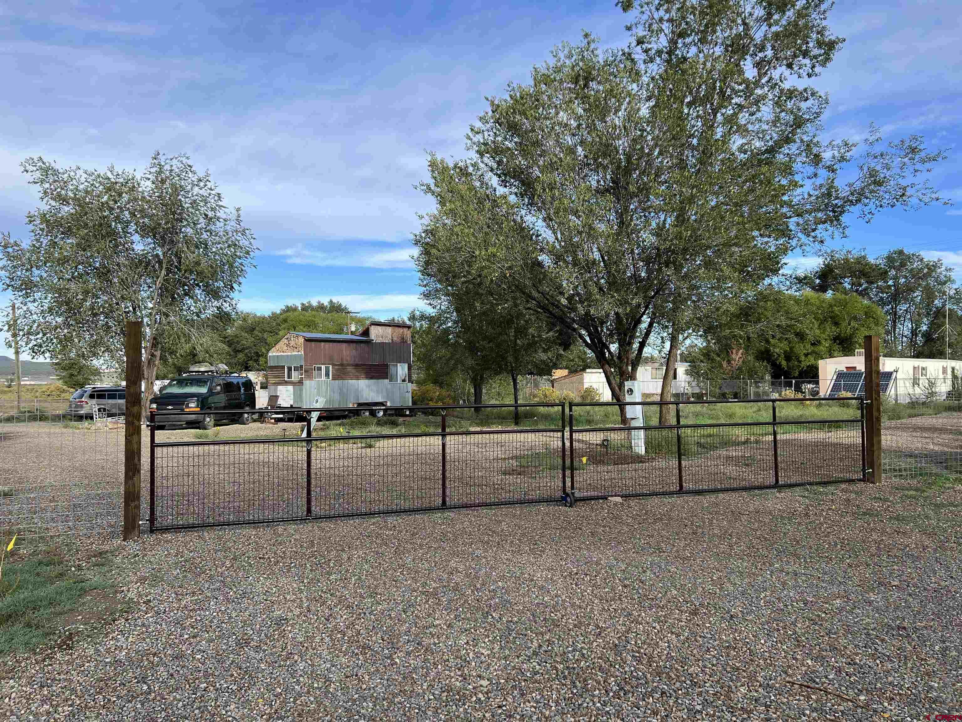 6493 Road 23.6 Cortez, CO 81321 - Photo 25 of 44 a view of a backyard with large trees