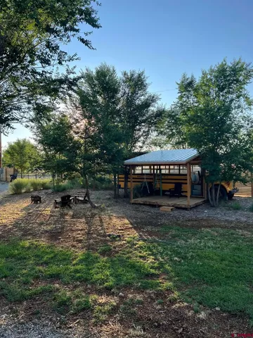 a view of a wooden deck with a backyard